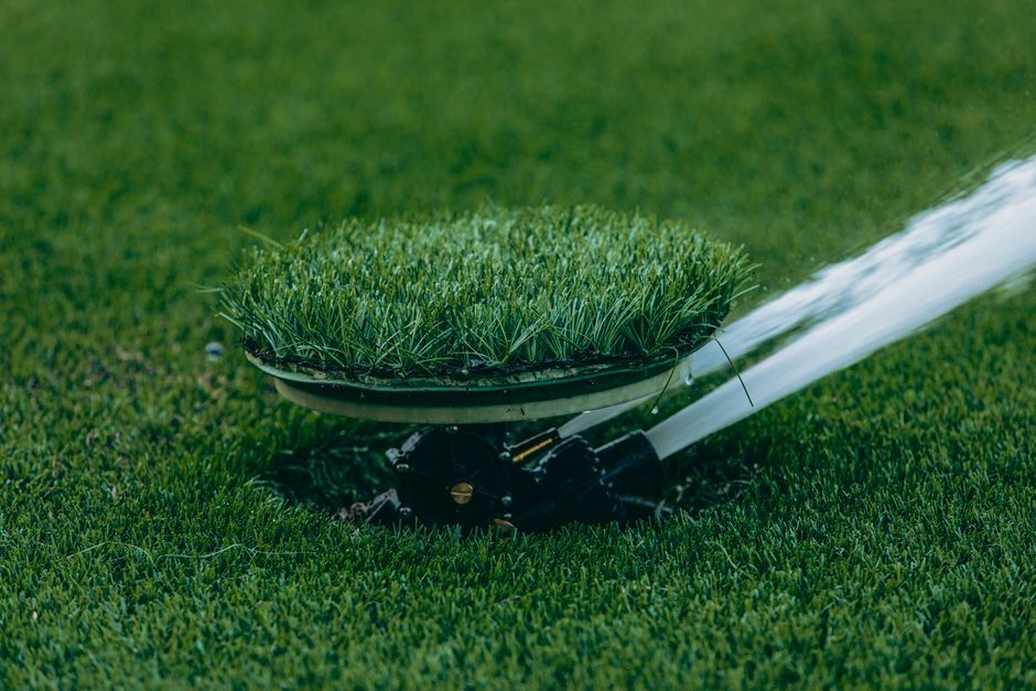 Irrigation sprinkler heads watering a green lawn in Summerville, South Carolina